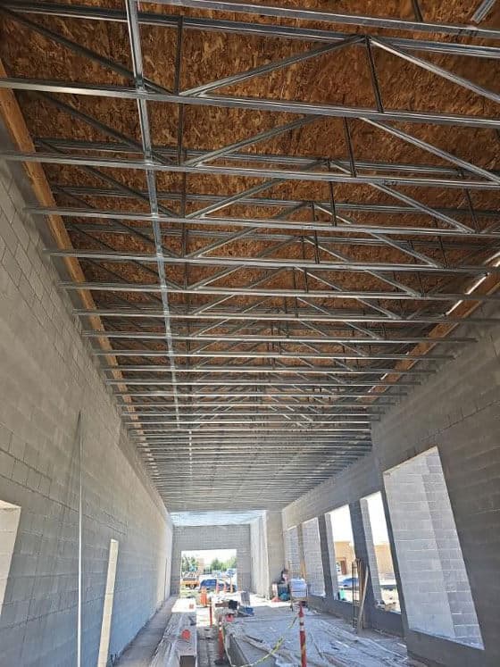 Long span steel roof trusses over masonry walls in a commercial building