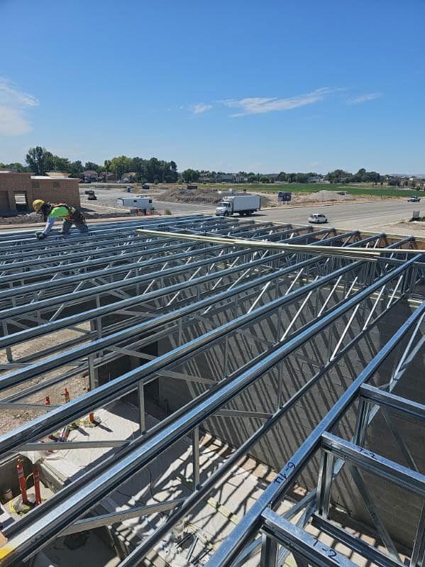 Numbered steel roof trusses set across a single storey commercial building