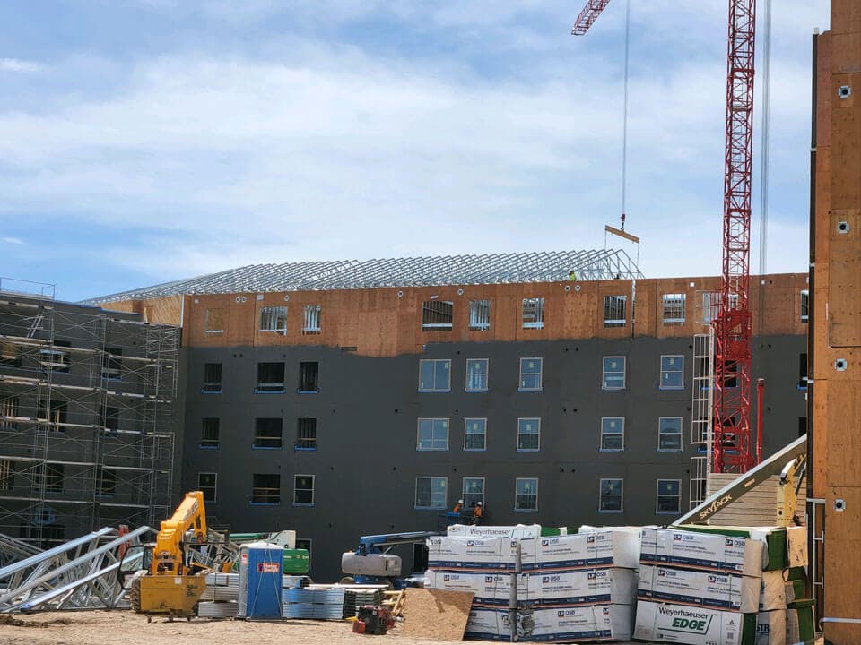 Panelized steel walls and roof trusses erected on a multifamily building